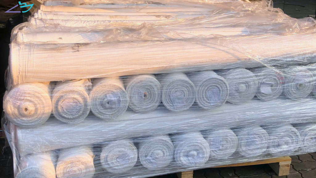 Textile fabric rolls wrapped and secured on a pallet
