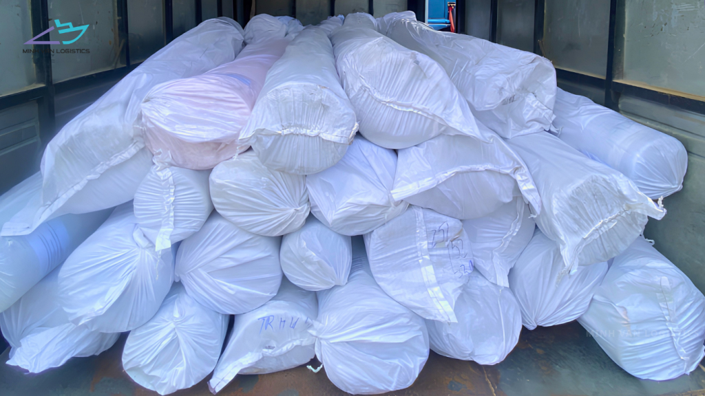 Wrapped textile fabric rolls stored in a logistics warehouse
